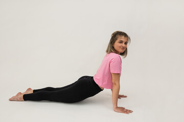 Sporty young woman does yoga or pilates exercise