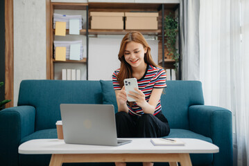 Young attractive Asian woman smiling thinking planning writing in notebook, tablet and laptop working from home at office .