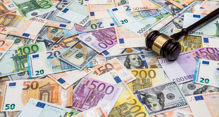 hammer of the judge on background of dollar and euro bills