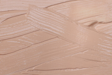 Beige cosmetic foundation cream background, texture
