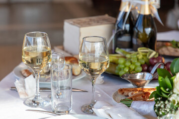 Close up of glasses of wine and snacks on the table