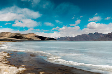 Icy Tranquility: A Captivating View of Frozen Pangong Lake under the Sunny Sky