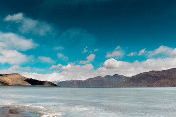 Icy Tranquility: A Captivating View of Frozen Pangong Lake under the Sunny Sky