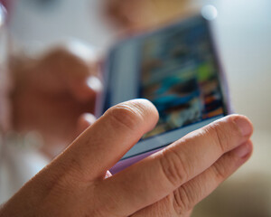 Middle age woman watching movie on her smartphone