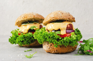 Delicious Burgers with Vegetables and Sauce, Fresh and Tasty Plant Based Meatless Burgers on Bright Background