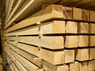 Stacked square shaped timbers in workshop