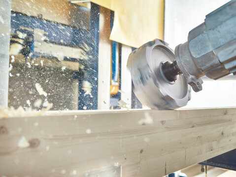 Close-up of machinery with timber in workshop