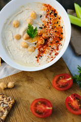 Healthy vegan homemade Hummus with olive oil and paprika with Chips. Homemade Hummus bowl Authentic cuisine. 