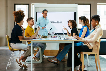 Business colleagues having discussion together at desk