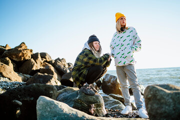 Two contemplative young women near sea