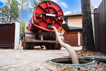 Sewage Tank truck. Sewer pumping machine. Septic truck. Pipe in the drainage pit. Pumping out...