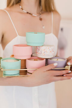 Woman holding scented candles in molds