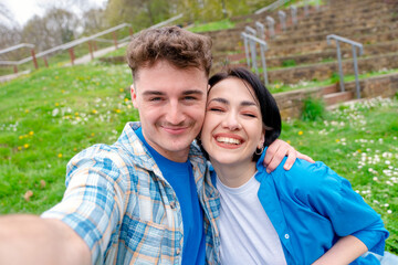 Smiling young couple taking selfie on smart phone - Powered by Adobe