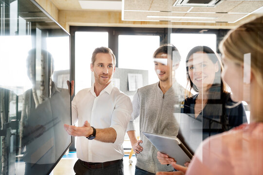 Businessman with colleagues having discussion in office