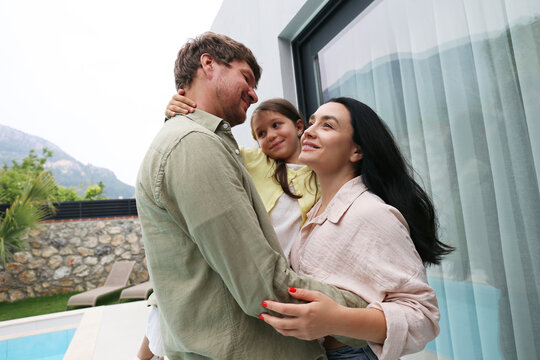 Happy family spending leisure time outside house