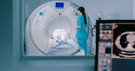 Nurse send patient to MRI capsule on moving table. Magnetic resonance imaging of brain. Room of...