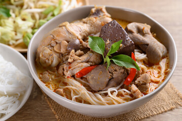 Thai rice noodles curry soup with chicken and coconut milk