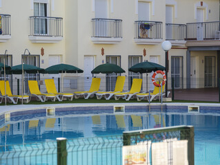 Chairs near swimming pool in residence