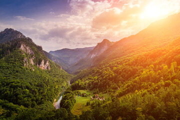 High mountains of Tara river canyon at sunset with cloudy sky. - obrazy, fototapety, plakaty