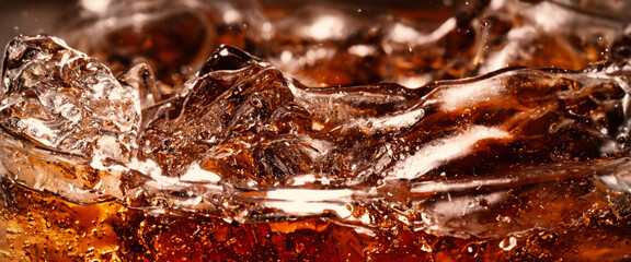 Splashing of Cola and Ice. Cola soda and ice splashing fizzing or floating up to top of surface. Close up of ice in cola water. Texture of carbonate drink with bubbles in glass. Cold drink background - obrazy, fototapety, plakaty