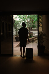 a tourist with a suitcase leaves the hotel
