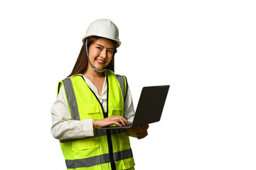 Smiling civil engineer woman wearing helmet and vest holding laptop isolated white background