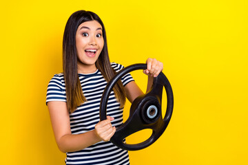 Photo of pretty funky lady wear striped dress driving automobile empty space isolated yellow color background