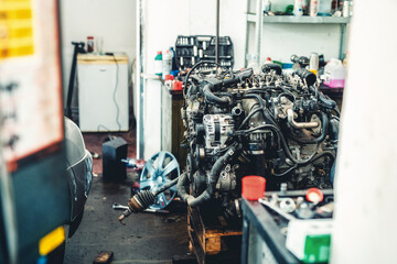 disassemble the engine from the car in the car workshop.