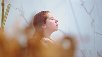 An attractive red-haired Caucasian woman showering 
