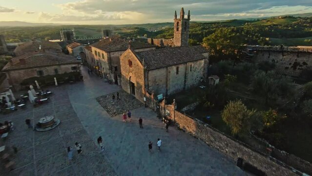 Fast aerial over the commune of Monteriggioni at sunset, Province of Siena, Italy. FPV Drone