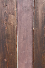 Wooden red planks with texture of a natural tree. Abstract background. A hardwood aged wall close-up.