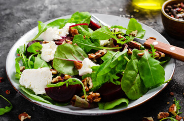 Fresh Salad with Beetroot, Feta Cheese, and Pecans, Healthy Vegetarian Meal on Dark Background