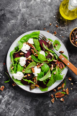 Fresh Salad with Beetroot, Feta Cheese, and Pecans, Healthy Vegetarian Meal on Dark Background