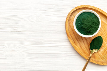 Dietary supplement for vegan Spirulina algae powder in bowl, top view