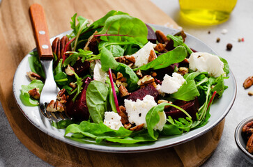 Fresh Salad with Beetroot, Feta Cheese, and Pecans, Healthy Vegetarian Meal on Grey Background