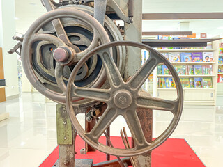 Parts of Old Fashioned Book Binding Machine made of iron wheels and gears for making books in...