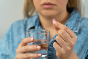 Woman takes pill with water glass. Pills and drugs, medicament, vitamins. Health care