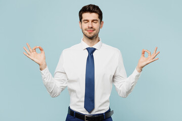 Young employee business man corporate lawyer wear classic formal shirt tie work in office hold spreading hands in yoga om aum gesture relax meditate try to calm down isolated on plain blue background.