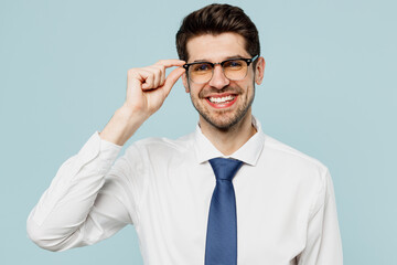Close up young serious calm successful employee business man corporate lawyer wear classic formal shirt tie work in office look camera isolated on plain pastel light blue background studio portrait.