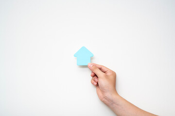 paper house on hand on white background, family house concept, family day care, real estate, housing and mortgage,foster home care or family day care, home minimal style.