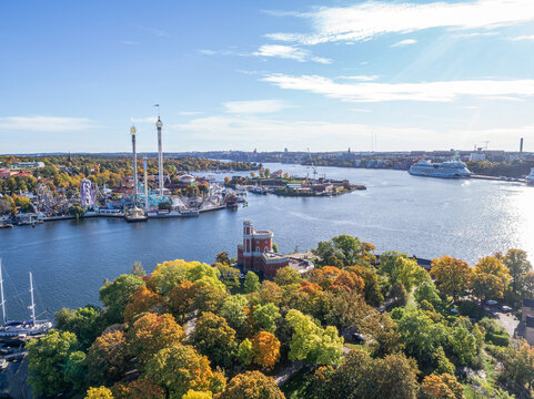 View of amusement park Grona Lund with carousels and tour rides on Djurgarden island Stockholm Sweden