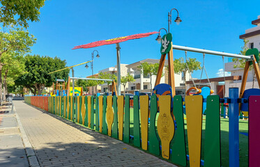 Children's playground with fence of different colors