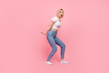 Full length photo of young excited girl unexpected hold large product object parcel delivery empty space isolated on pink color background