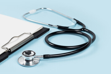 blank clipboard with modern stethoscope, space for messages