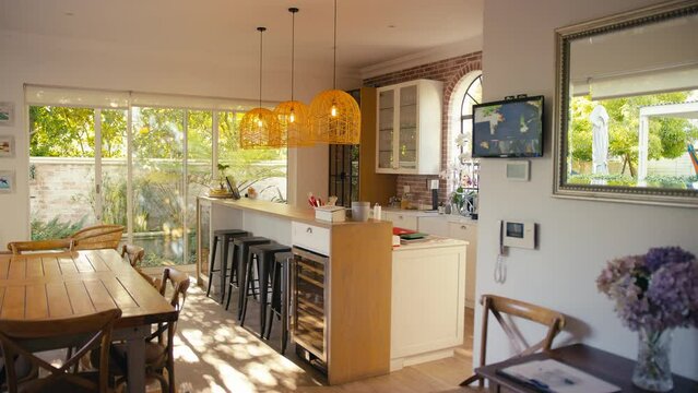 Camera tracks across interior of modern kitchen with counter and cctv security - shot in slow motion