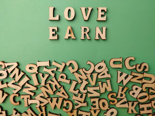 Wooden letter toy arranged the word LOVE EARN