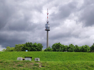 Obraz premium view of the Danube Tower in Vienna with cloudy sky in the background