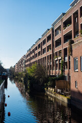 View of the street with canal houses and its reflection