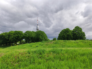 view of the Danube Tower in Vienna with cloudy sky in the background
