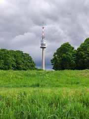 Obraz premium view of the Danube Tower in Vienna with cloudy sky in the background